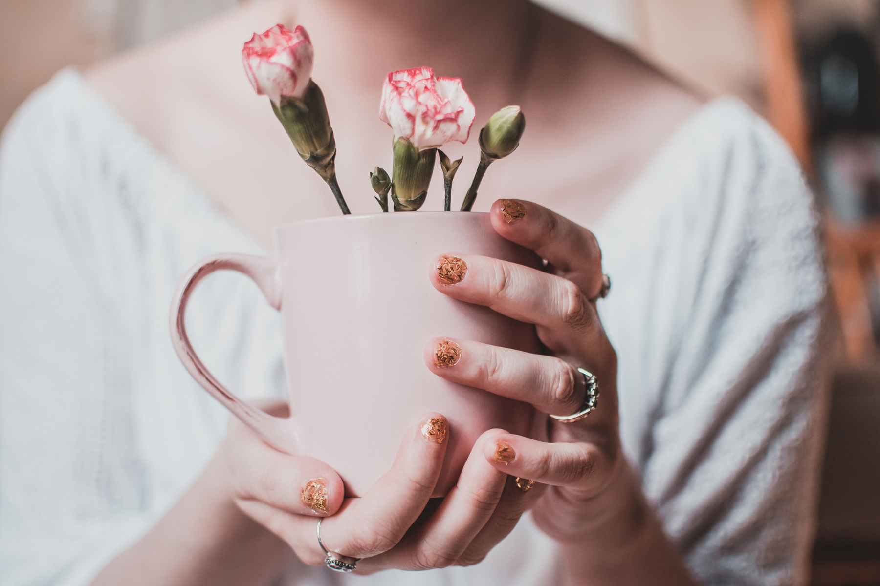 Woman Wearing White Shirt Holding Pink Mug With White Petaled Flowers